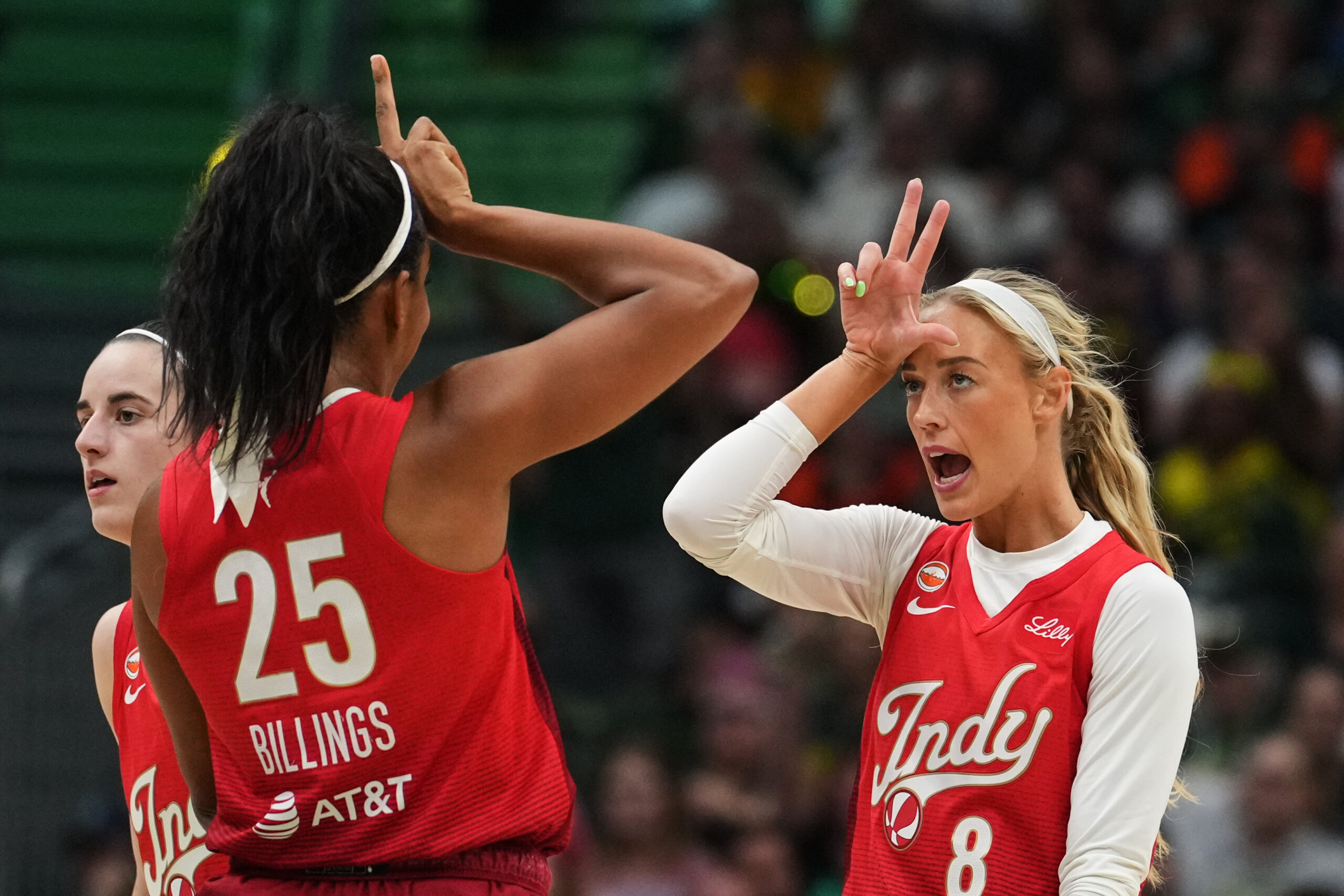 Indiana Fever guard Sophie Cunningham (8) reacts to making a basket with teammate Monique Billings (25) during the first half of a WNBA basketball game against the Seattle Storm, Tuesday, July 28, 2026, in Seattle.