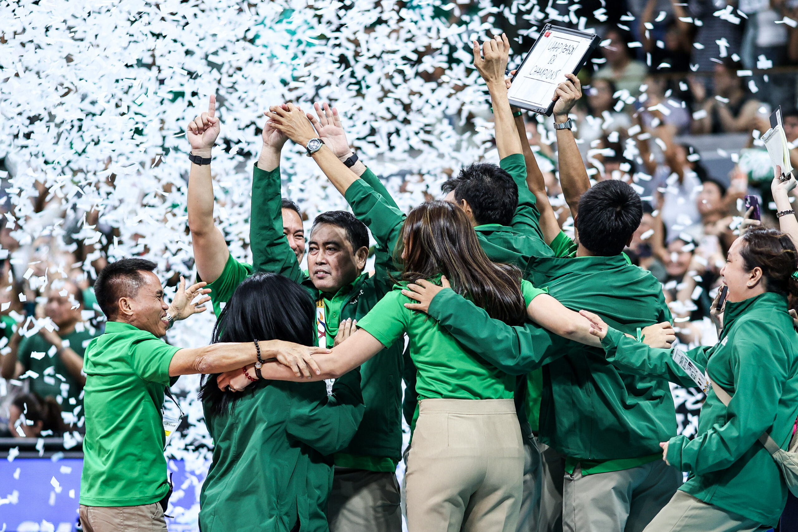 Coach Ramil de Jesus and the La Salle Lady Spikers celebrate after winning the championship in the UAAP Season 88 women's volleyball tournament, beating NU Lady Bulldogs. 