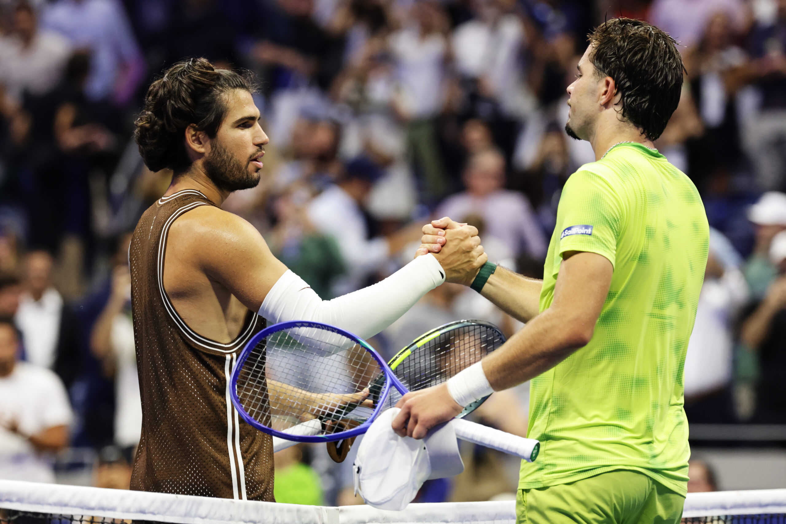 Carlos Alcaraz, of Spain, left, meets Jaime Faria, of Portugal, at the net after winning a match during the second round of the U.S. Open tennis championships, Wednesday, Sept. 2, 2026, in New York. (AP Photo/Adam 