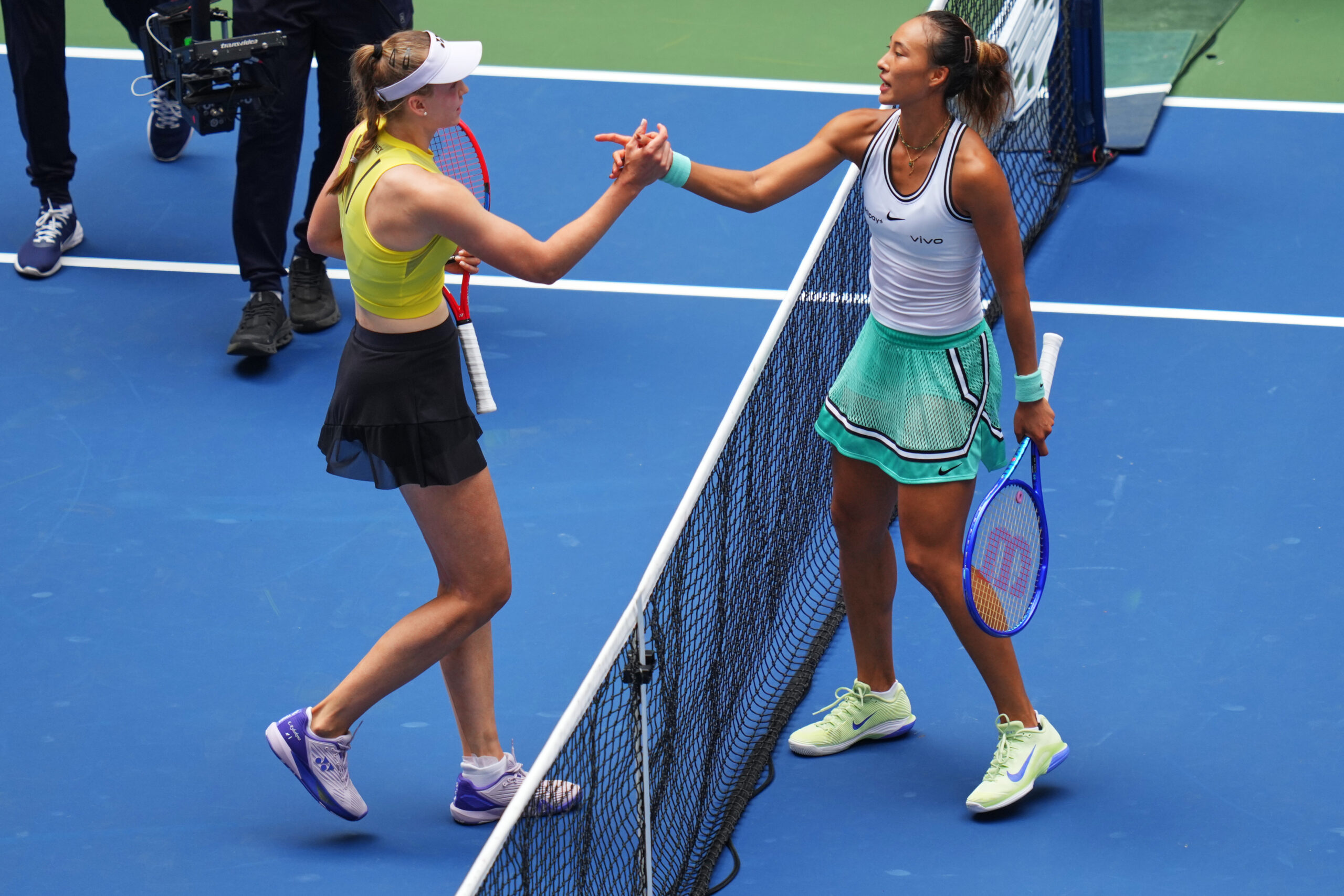 Elena Rybakina, of Kazakhstan, left, and Qinwen Zheng, of China, meet at the net after Rybakina won their match during the quarterfinal round of the U.S. Open tennis championships, Wednesday, Sept. 9, 2026, in New York. (AP Photo/Kirsty