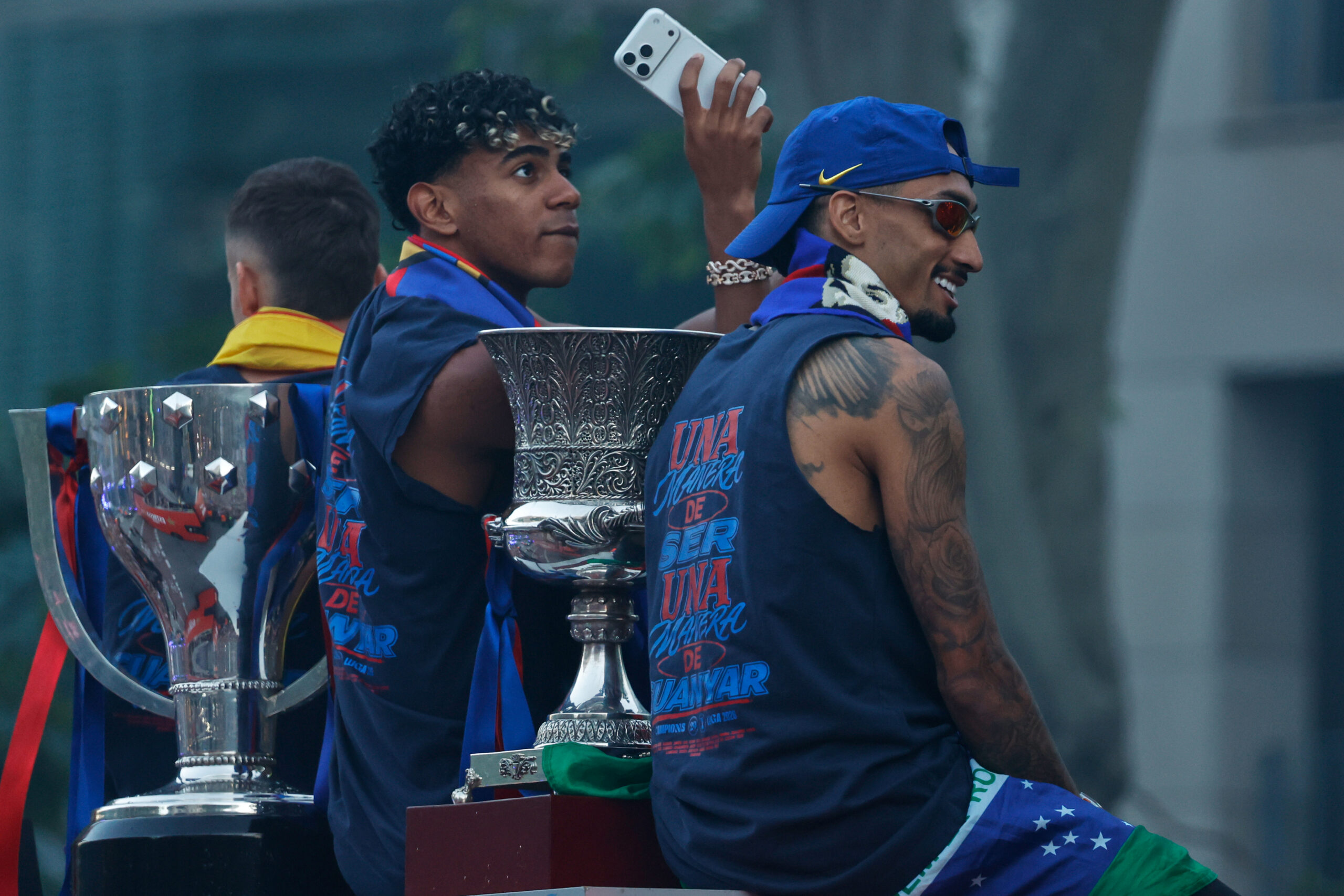 FC Barcelona players Lamine Yamal, left, and Raphinha celebrate atop a bus after winning the Spanish La Liga title in Barcelona, Spain, Monday, May 11, 2026. 