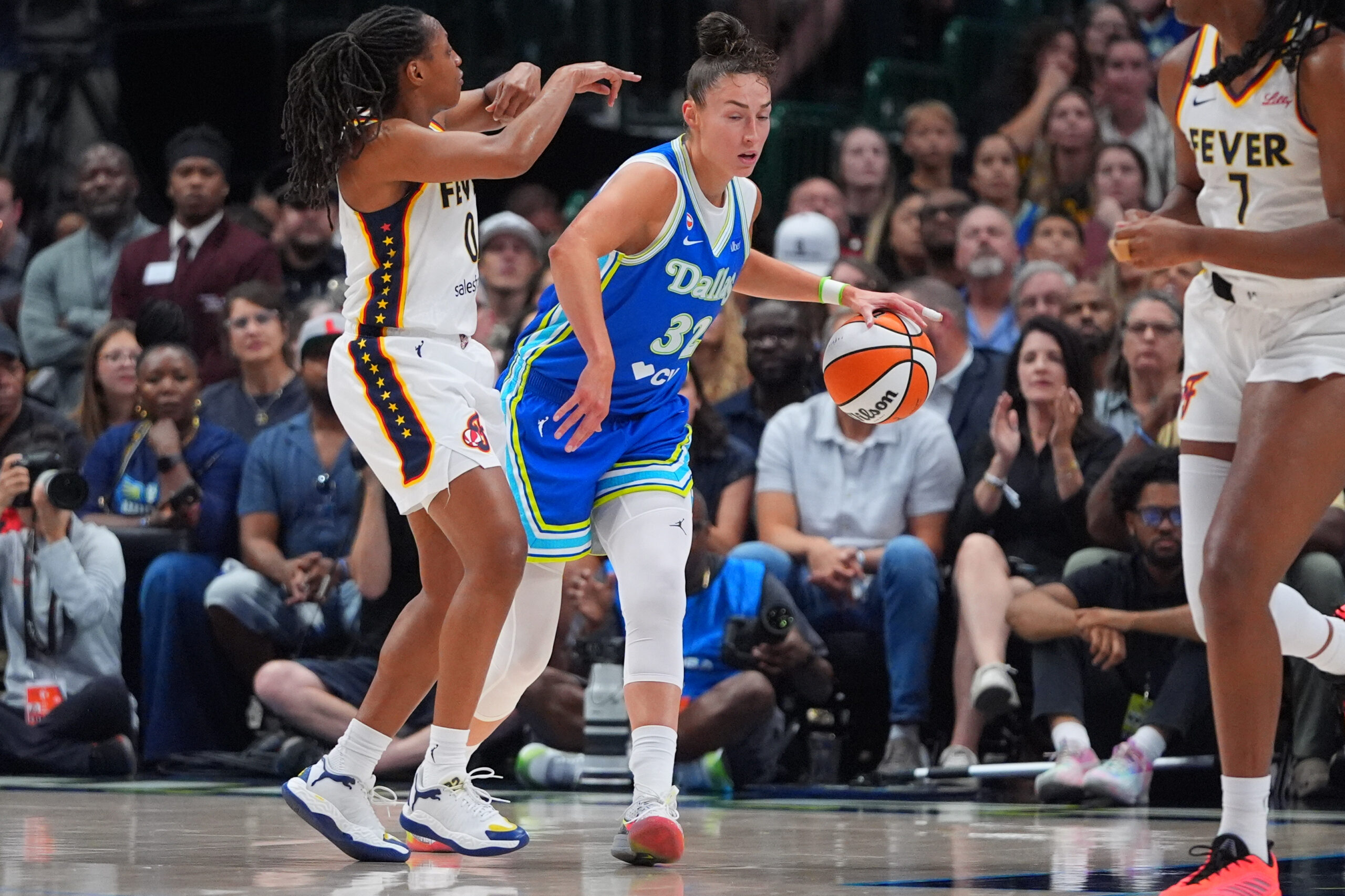 Dallas Wings forward Jessica Shepard (32) tries to dribble past Indiana Fever guard Kelsey Mitchell (0) during the first half of a WNBA basketball game in Dallas, Thursday, Aug. 20, 2026.