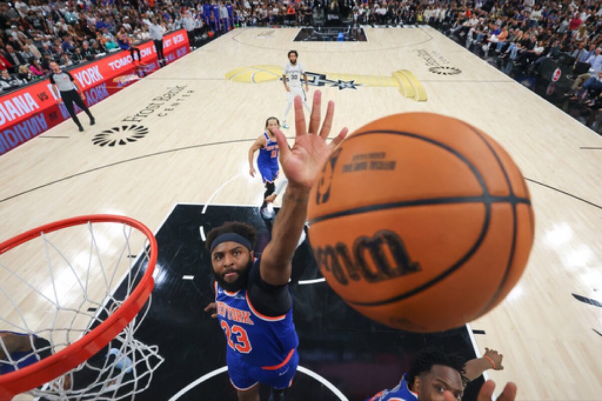 Knicks center Mitchell Robinson rises to block a shot.