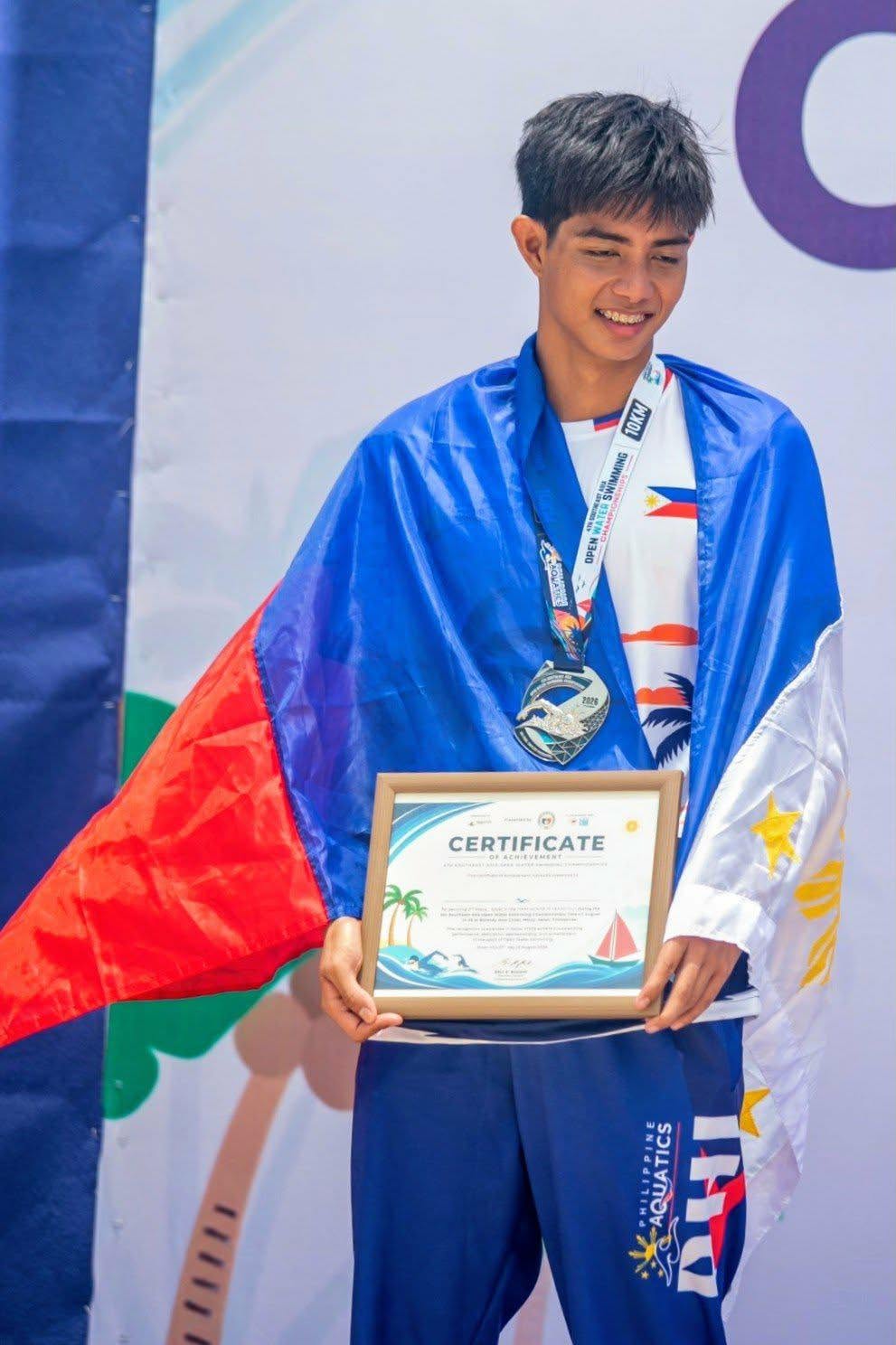 Paulo Dominick Della is all smiles on the podium after receiving his silver medal in the men's 18-19-year-old age group division the 4th Southeast Asia Open Water Swimming Championships.