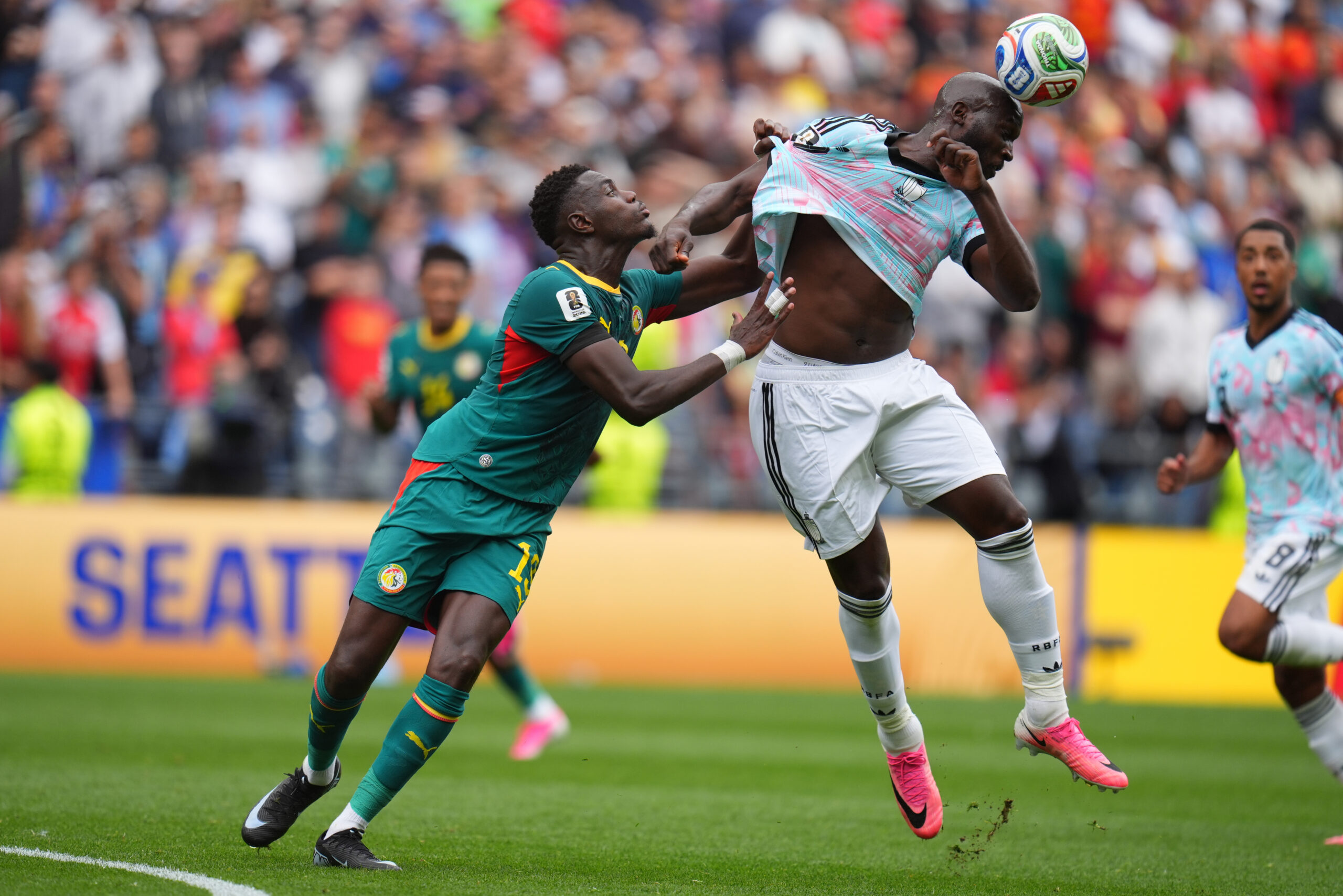 Senegal's Iliman Ndiaye (13) pulls Belgium's Romelu Lukaku (9) during the World Cup round of 32 soccer match between Belgium and Senegal in Seattle, Wednesday, July 1, 2026.