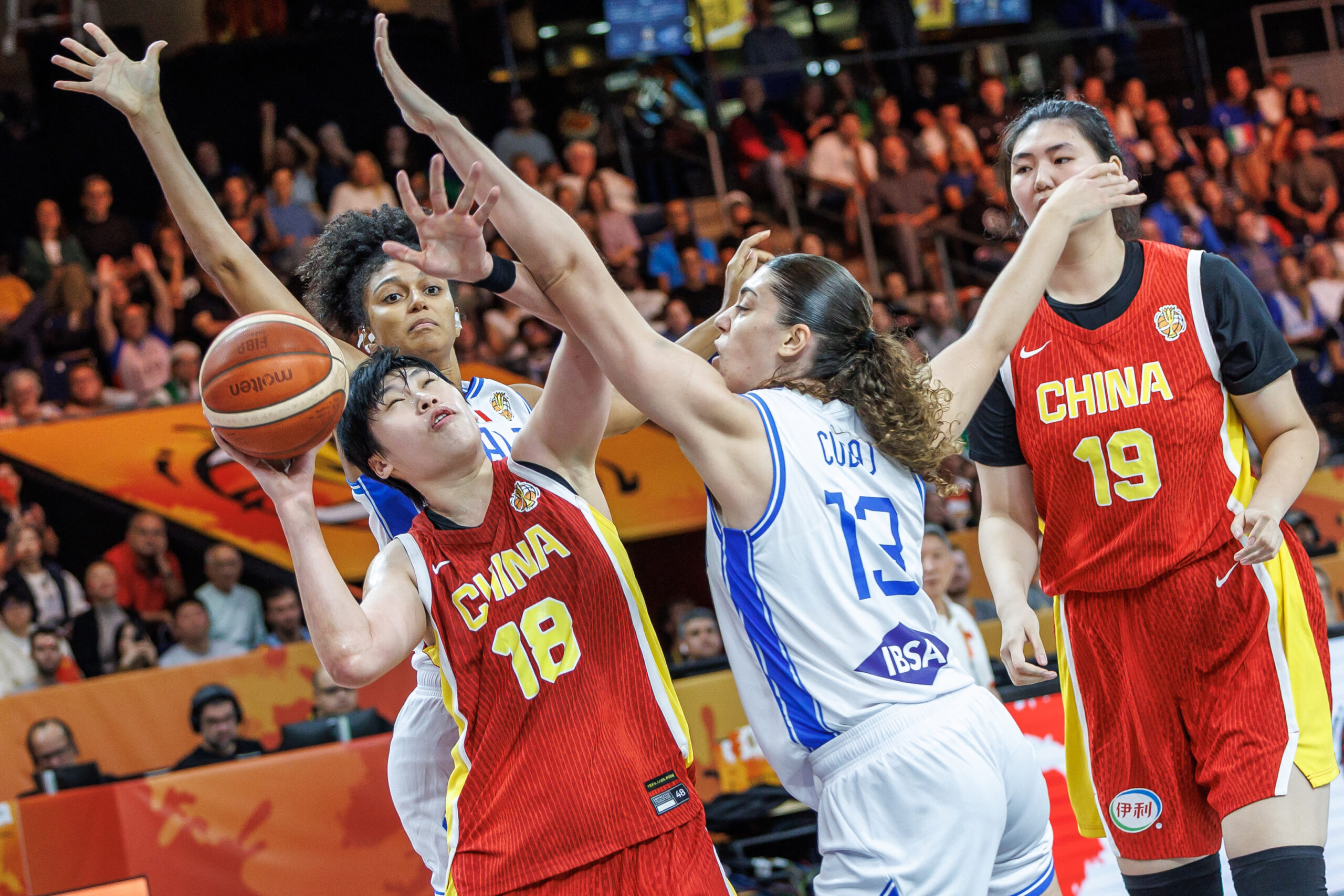 China's Chen Mingling, front left, and Italy's Lorela Cubaj, front right, challenge for the ball during the Fiba women's World Cup basketball match between Italy and China, in Berlin, Germany, Monday, Sept. 7, 2026. (Andreas Gora