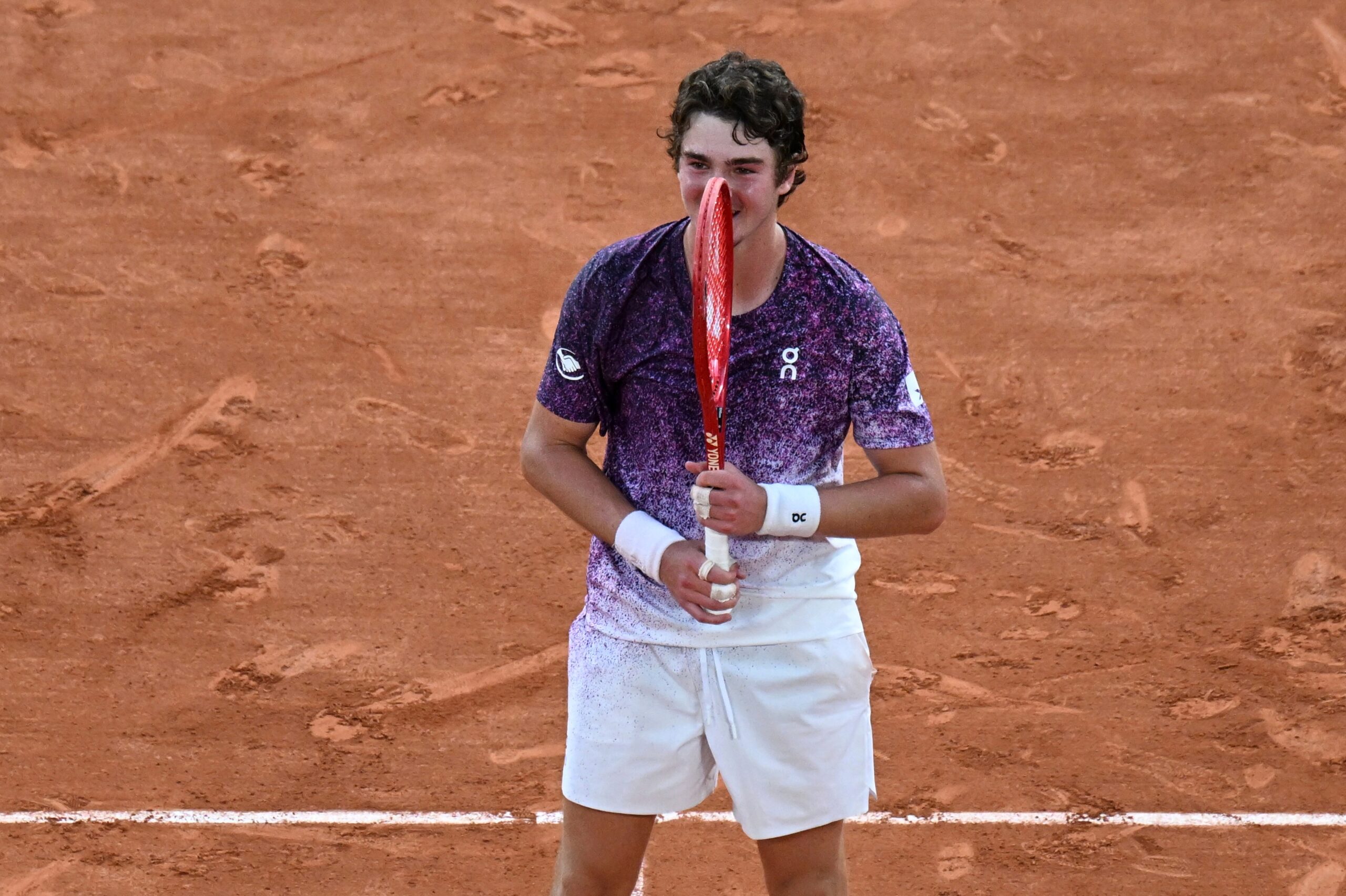 Joao Fonseca of Brazil celebrates winning the third round men's singles tennis match against Novak Djokovic of Serbia at the French Open tennis tournament in Paris, Friday, May 29, 2026.