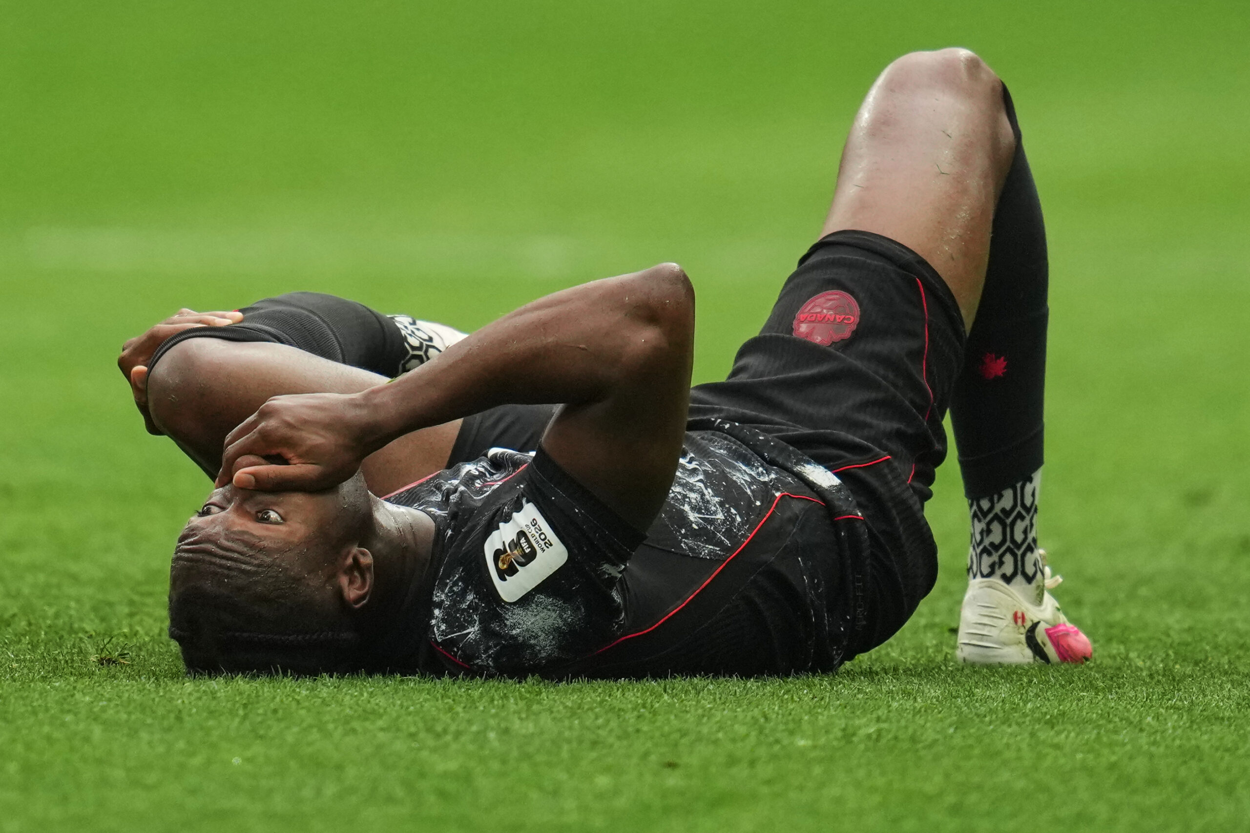 Canada's Ismael Kone reacts on the ground after sustaining an injury during the World Cup Group B soccer match against Qatar in Vancouver, British Columbia, Thursday, June 18, 2026.