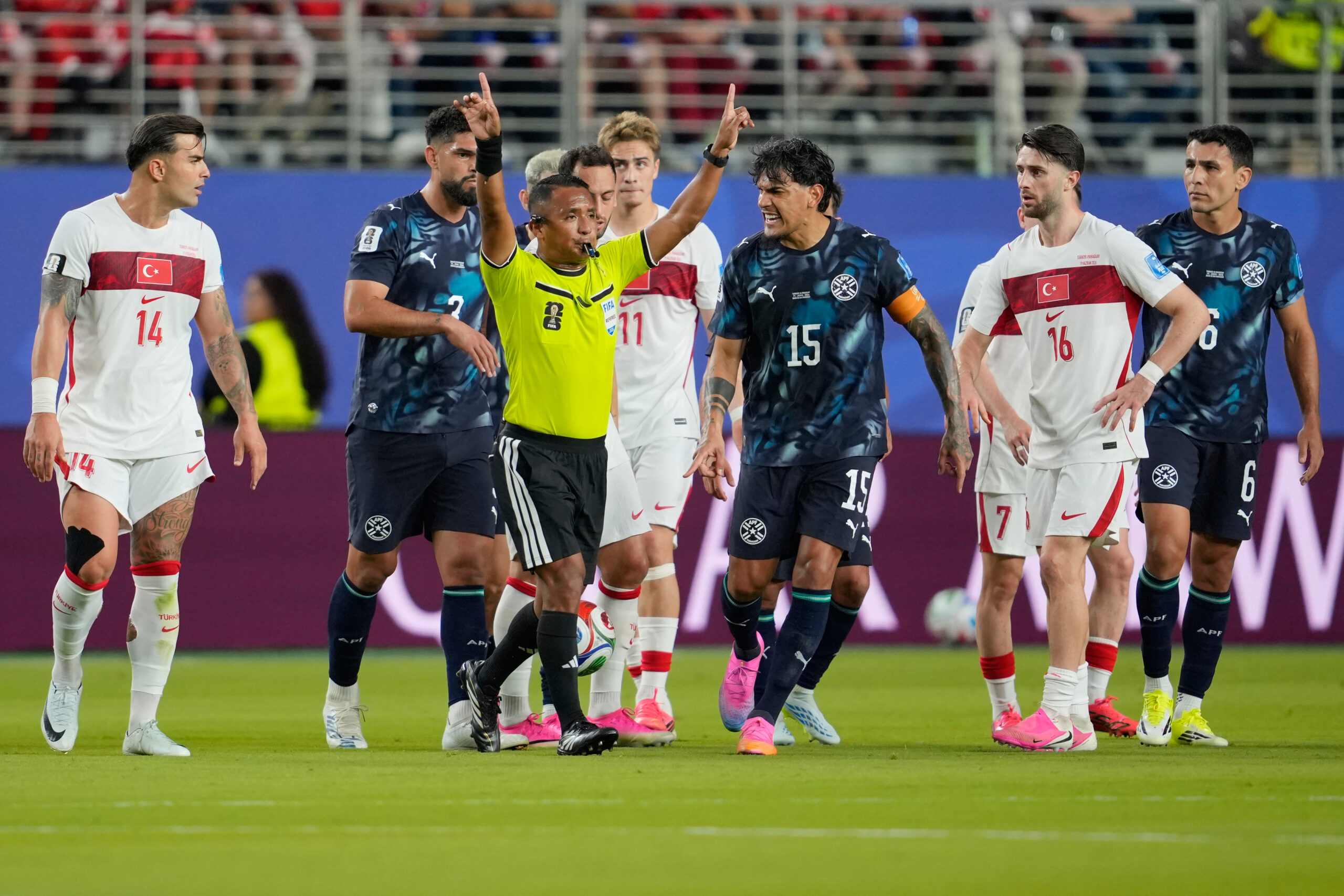 Referee Ivan Arcides Barton Cisneros, of El Salvador, signals to ask for a VAR review before issuing a red card to Paraguay's Miguel Almiron (10) during the World Cup Group D soccer match between Turkey and Paraguay in Santa Clara, Calif., near San Francisco, Friday, June 19, 2026.