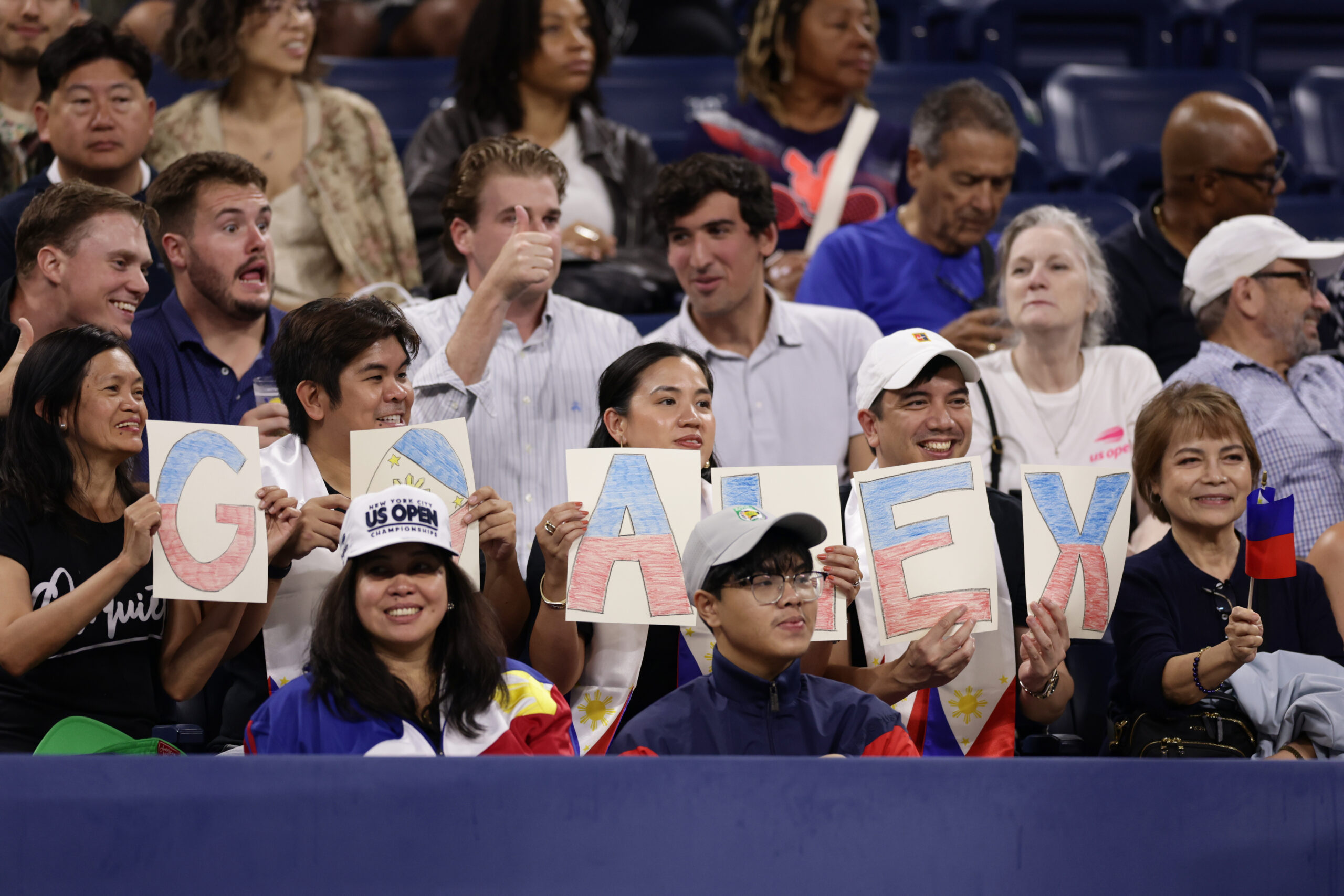 Fans of Alexandra Eala, of the Philippines, spell out "GO ALEX" with letters before her match against Mary Stoiana, of the United States, in the first round of the U.S. Open tennis championships Tuesday, Sept. 1, 2026, in New York.