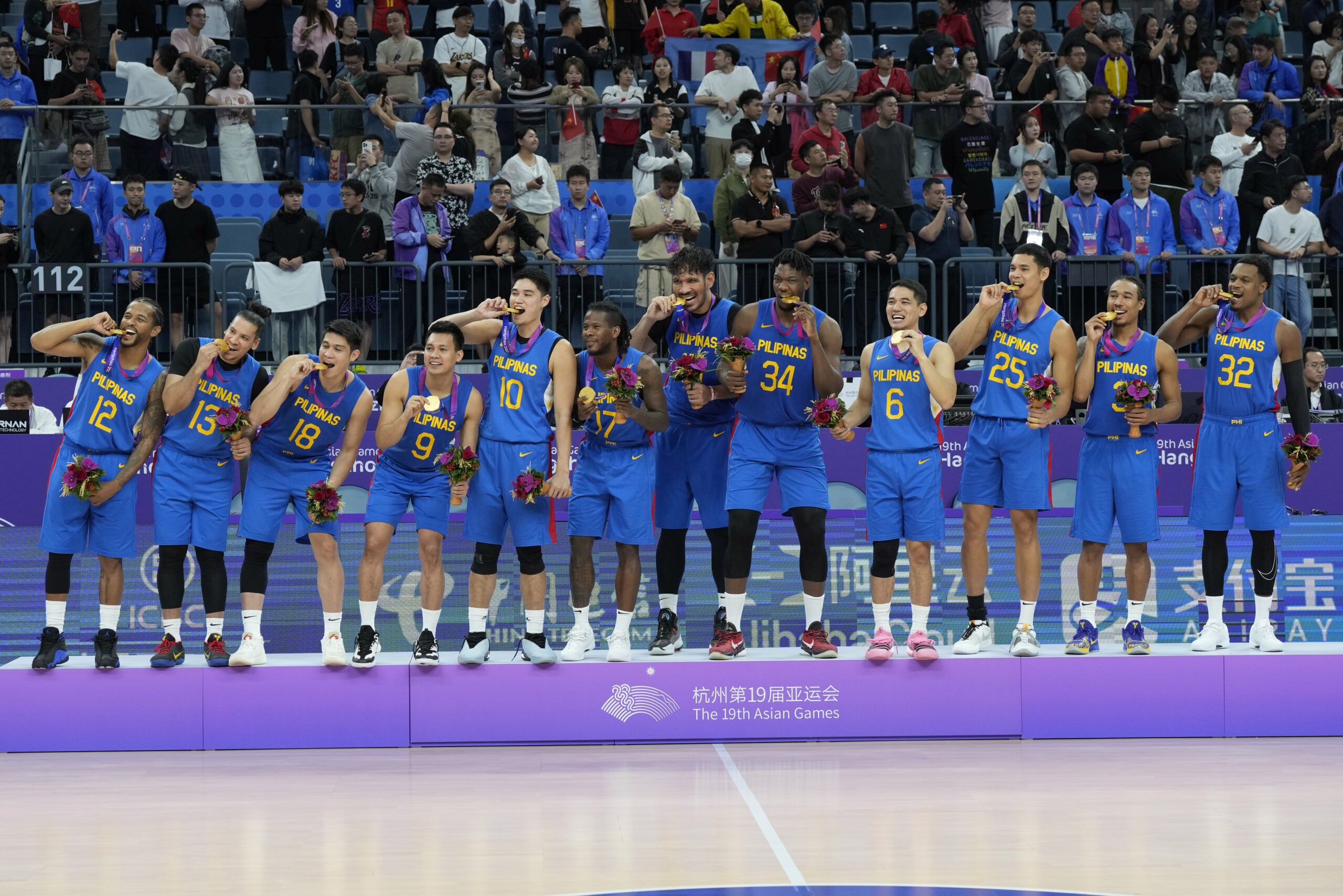 Gilas Pilipinas Team Philippines celebrates with their gold medals after defeating Jordan in their men's basketball gold medal at the 19th Asian Games in Hangzhou, China, Friday, Oct. 6, 2023.