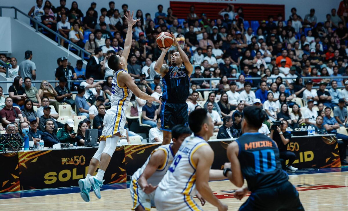 Chris Newsome (with ball) comes through for Meralco.