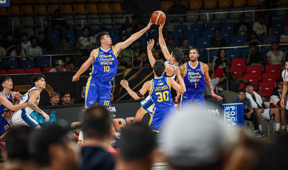 Magnolia Hotshots' Ian Sangalang blocks Meralco Bolts' Chris Banchero during a game in the 2026 PBA Governors' Cup.